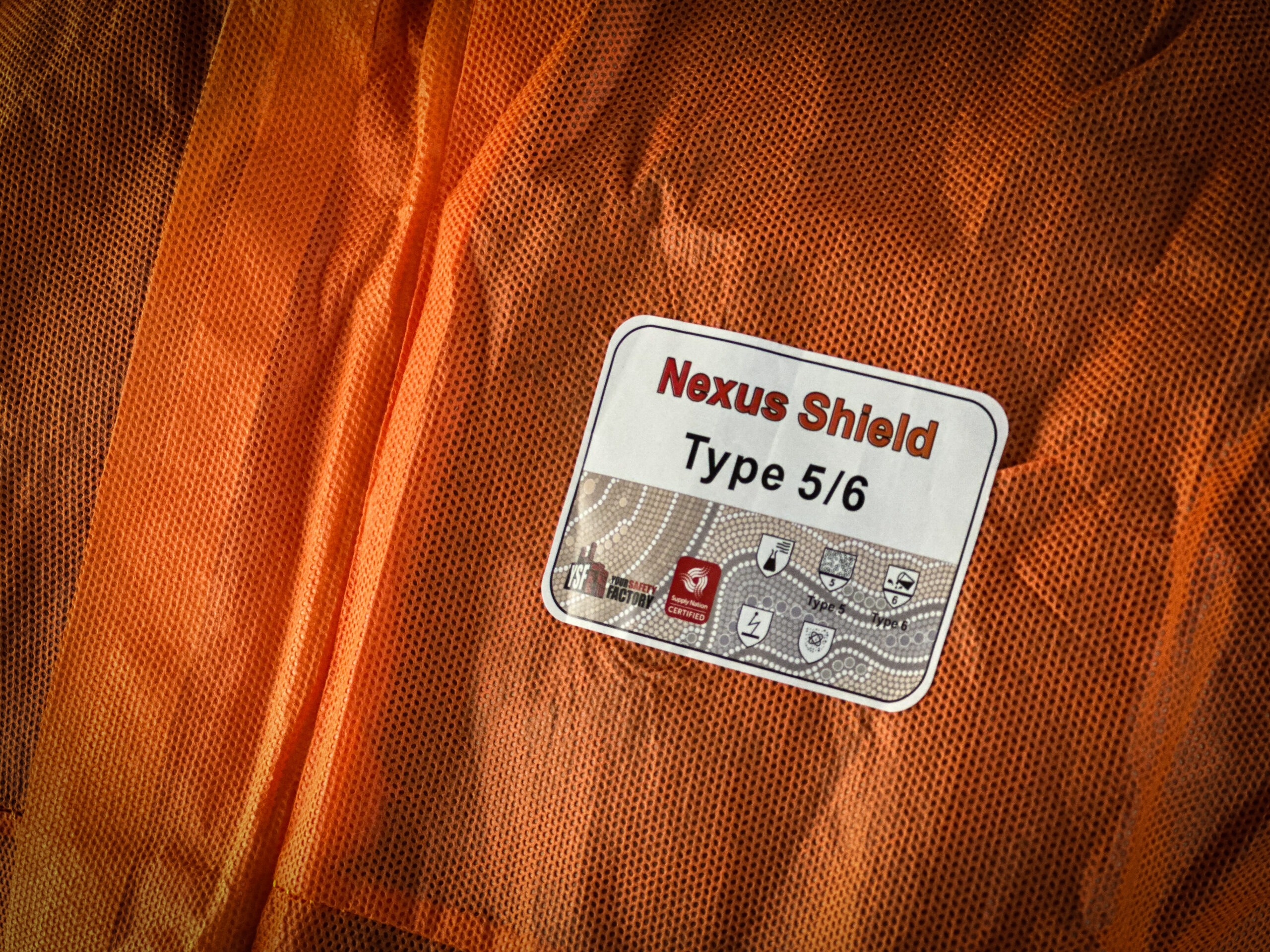 Tradie wearing Nexus Shield SMS Type 5/6 Coverall Orange from Your Safety Factory