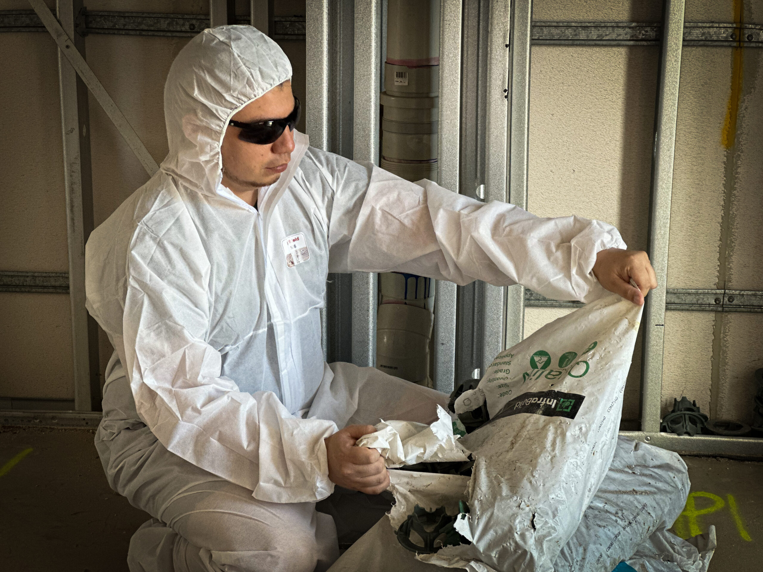 Tradie wearing Nexus Shield SMS Type 5/6 Coverall White from Your Safety Factory